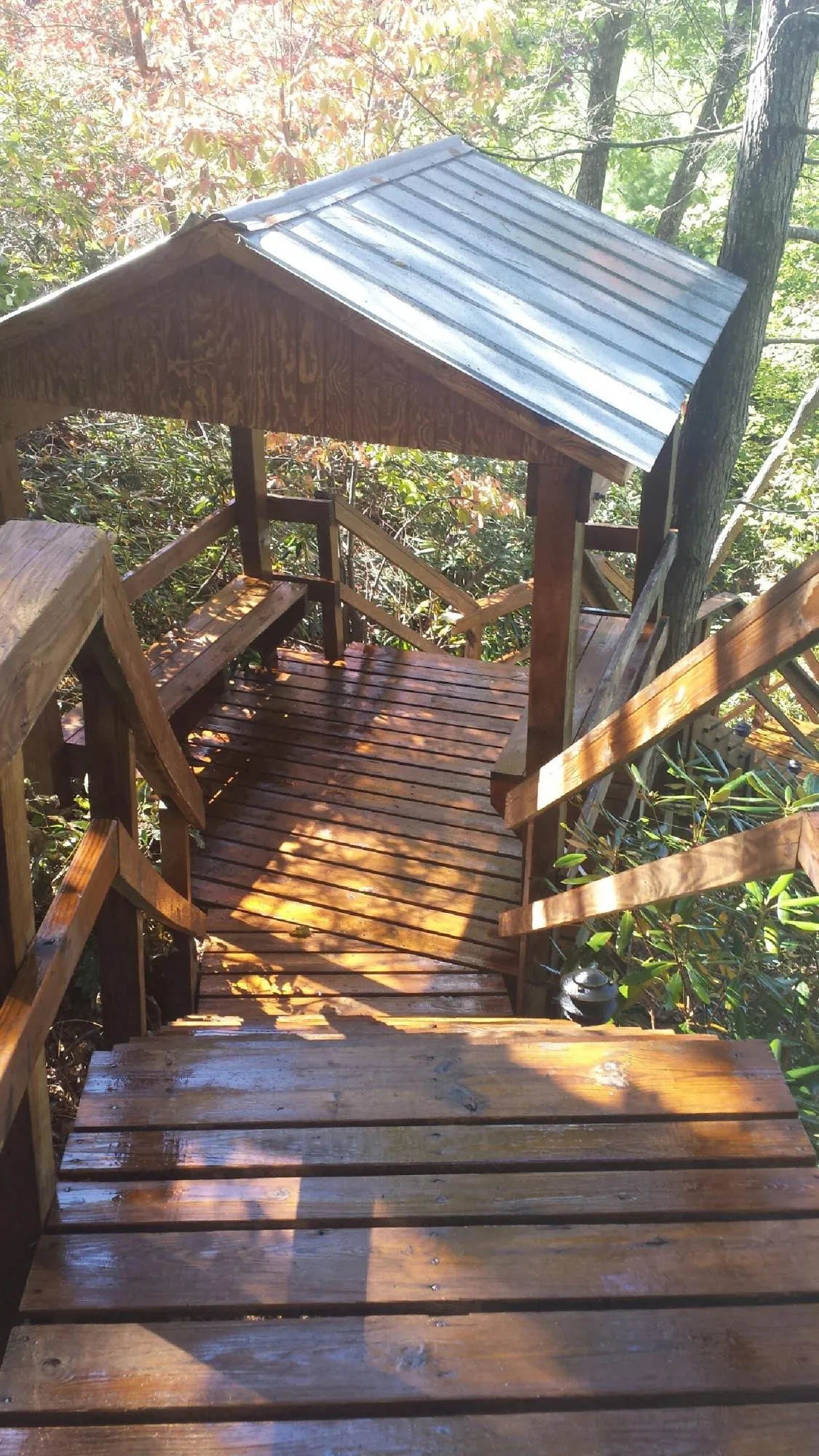 Freshly stained wood walkway and covered shelter with a metal roof in Star City