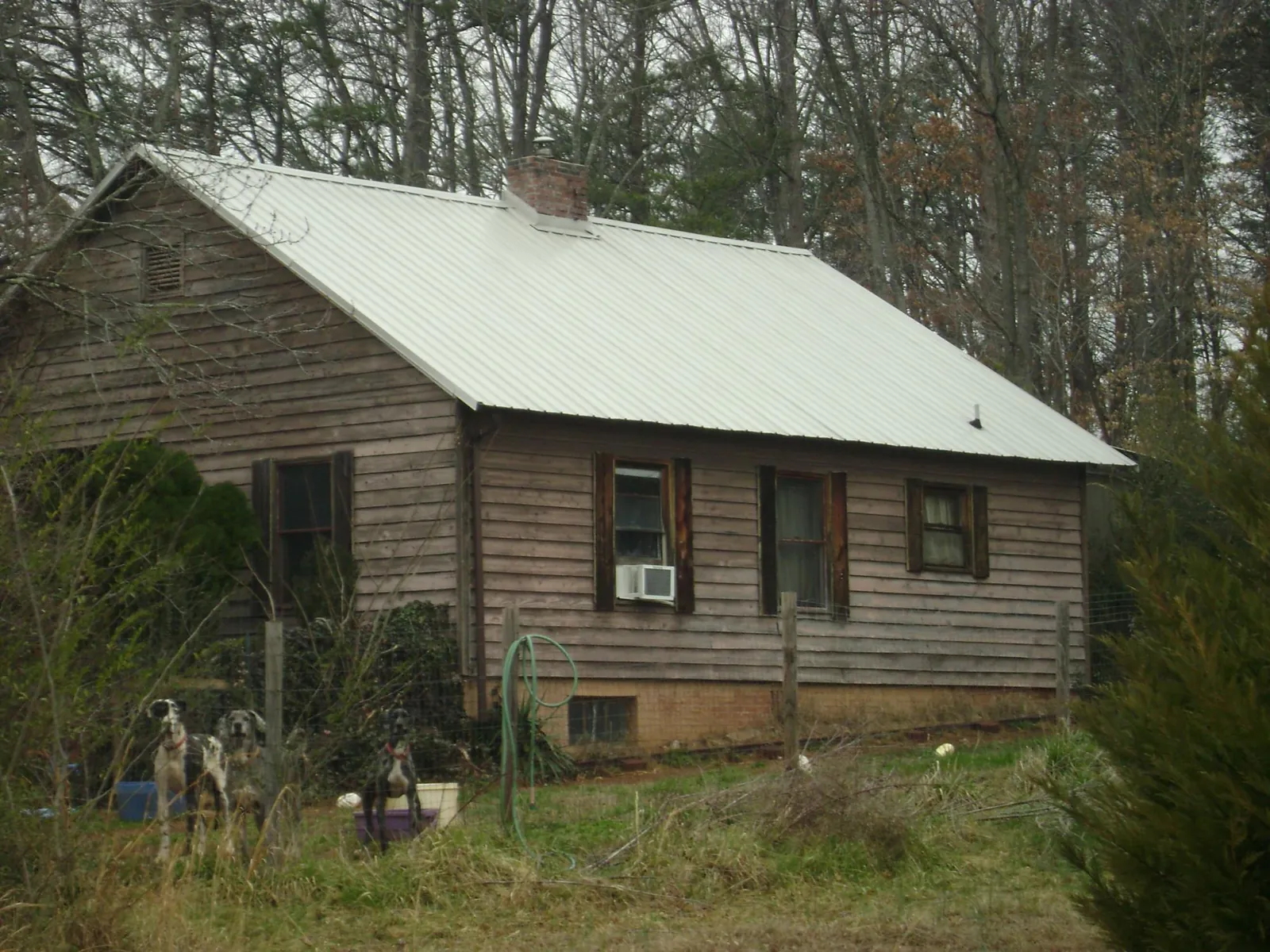 White metal roof on an old wood sided farmhouse, from a Metal Roof Installation job in Star City